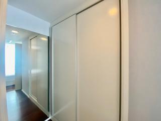 Bright hallway interior with sliding doors and hardwood flooring