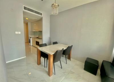 Modern dining area with open kitchen in the background