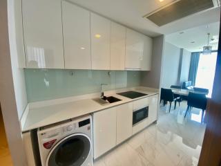 Modern kitchen with built-in appliances and adjacent dining area