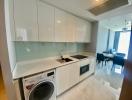 Modern kitchen with built-in appliances and adjacent dining area