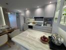 Modern kitchen with marble countertop and well-organized cabinetry