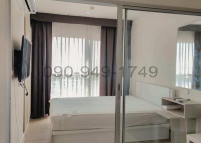 Modern bedroom with glass sliding door and balcony access