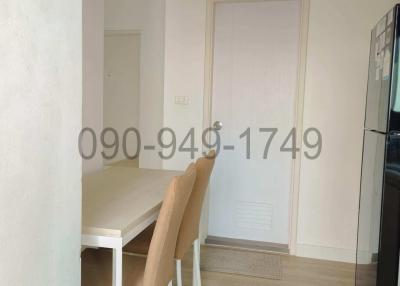 Compact dining area with natural light next to the kitchen