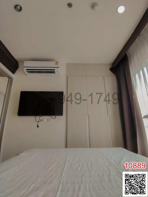 Modern bedroom with mounted television and air conditioner