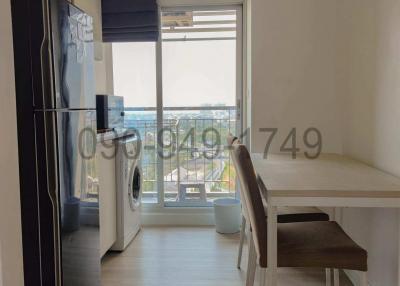 Modern kitchen with large windows and electrical appliances