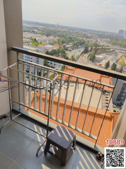 High-rise apartment balcony with city view and outdoor seating