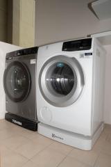 Modern appliances in a laundry room with a Toshiba and Electrolux washer and dryer