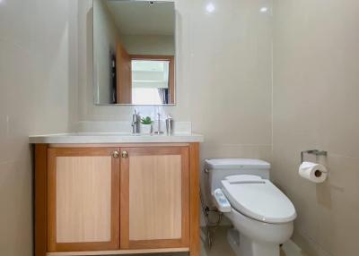 Contemporary bathroom interior with wooden vanity cabinet and mirror