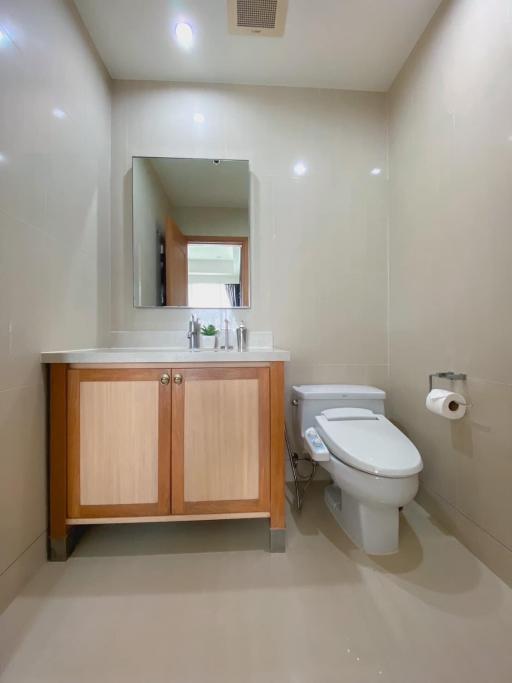 Contemporary bathroom interior with wooden vanity cabinet and mirror