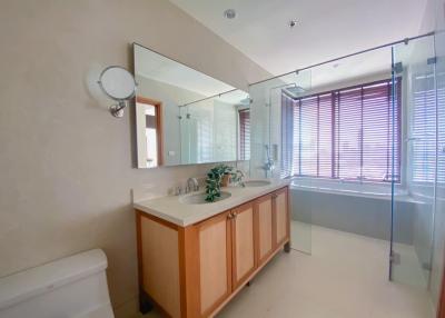 Spacious bathroom with large mirror and modern fixtures