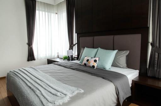 Modern bedroom interior with queen-sized bed and elegant decor