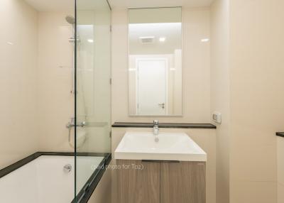 Modern bathroom with glass shower enclosure and vanity mirror