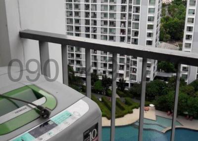 Balcony view overlooking apartment complex with swimming pool