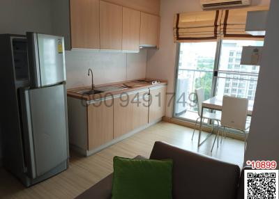 Compact kitchen with modern appliances and a small dining area by the window