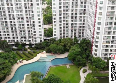 High-rise residential buildings with outdoor pool and green areas