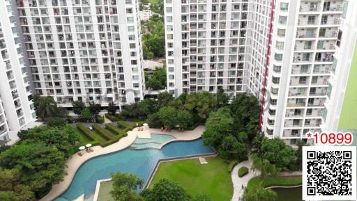 High-rise residential buildings with outdoor pool and green areas