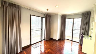 Bright bedroom with hardwood floors and city view