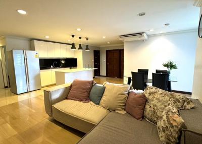 Spacious open-plan living room with modern kitchen and comfortable seating area