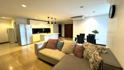 Spacious open-plan living room with modern kitchen and comfortable seating area