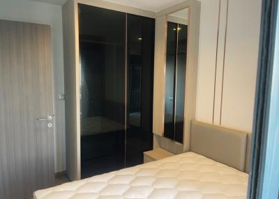 Cozy bedroom interior with mirror wardrobe doors and comfortable bed