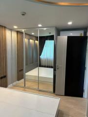 Modern bedroom with mirrored wardrobe and hardwood floors