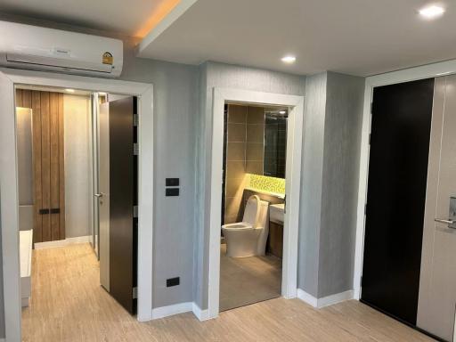 Modern hallway with wooden doors leading to various rooms