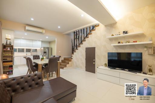 Modern living room with open kitchen and staircase
