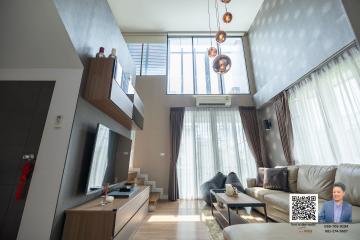 Spacious living room with high ceiling and modern decor