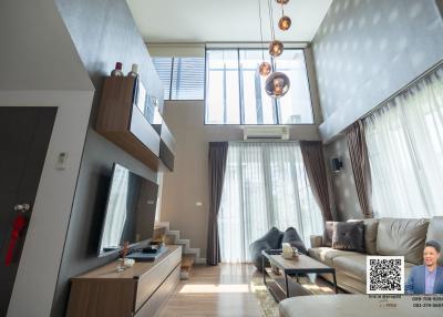 Spacious living room with high ceiling and modern decor