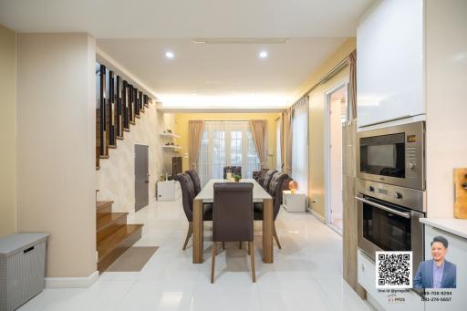 Modern kitchen with dining table and staircase