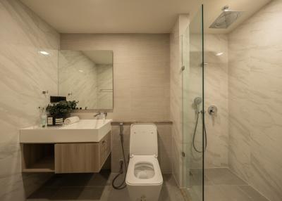 Modern bathroom interior with glass shower and elegant finishings