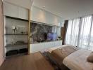 Modern bedroom with an integrated entertainment unit and a city view