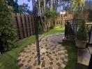 Cozy backyard garden with paving stone pathway and lush greenery