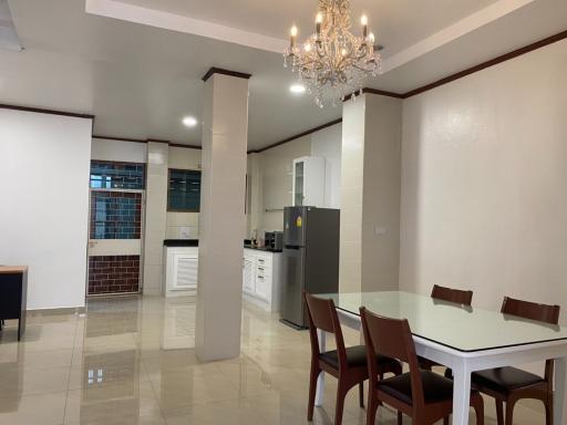 Spacious kitchen with dining area, modern appliances, and tiled flooring