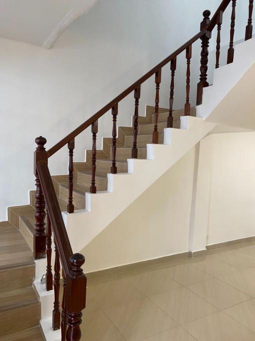 Elegant wooden staircase with tiled steps in a home interior