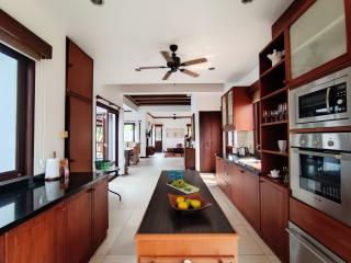 Spacious kitchen with modern appliances and wooden cabinetry