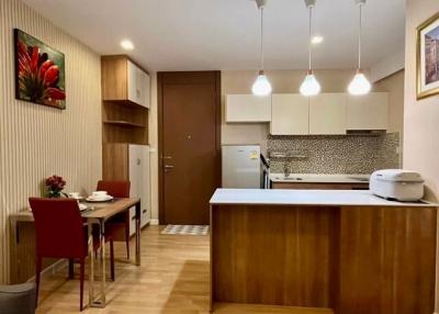 Modern kitchen with dining area and elegant lighting