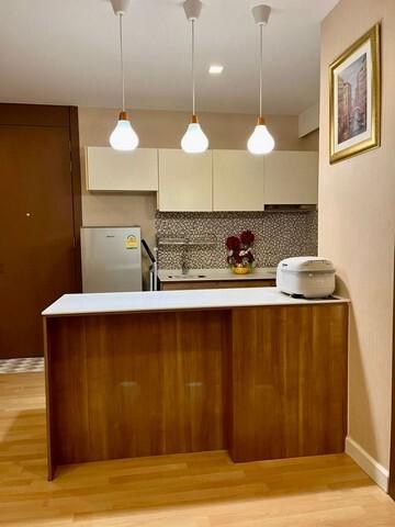 Modern kitchen with wooden cabinets and pendant lighting