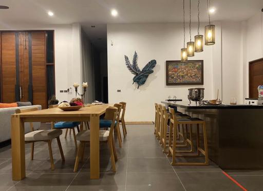 Modern dining room with wooden table and art decoration