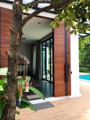 Modern home entrance with wooden features and poolside view