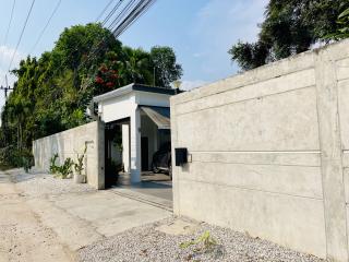 Modern home exterior with high privacy walls and gated entrance