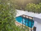 Luxurious poolside with lush greenery at sunset