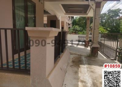 Spacious front porch of a residential building with parking space and overhang for weather protection