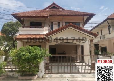 Two-story residential house with a tiled roof and balcony