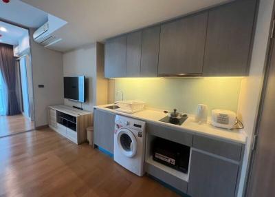 Modern kitchen with integrated appliances and wooden flooring