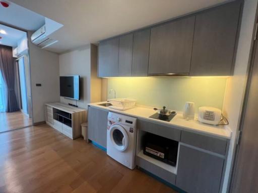 Modern kitchen with integrated appliances and wooden flooring