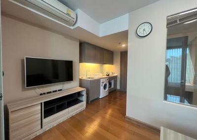 Compact modern studio apartment interior with integrated appliances