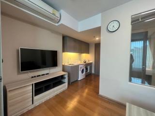 Compact modern studio apartment interior with integrated appliances