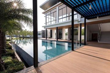 Modern two-story house with a swimming pool and wooden decking