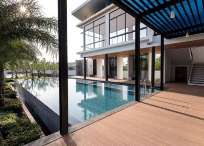 Modern two-story house with a swimming pool and wooden decking